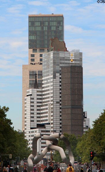 Kurfurstendam streetscape with Kaiser Wilhelm Memorial Church over Broken chain sculpture. Berlin, Germany.