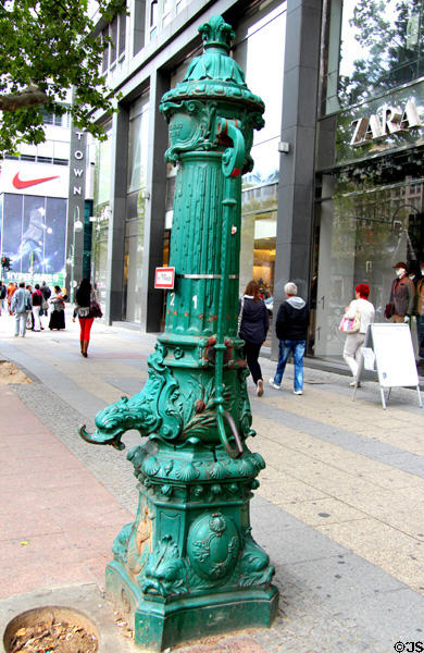 Antique cast iron water pump by Schoening of Berlin on Kurfurstendam. Berlin, Germany.