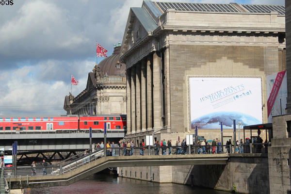 Train crosses Museum Island beyond Pergamon Museum. Berlin, Germany.