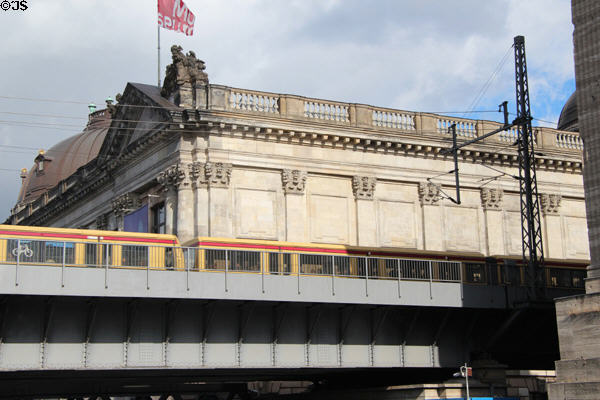 Subway train crosses Museum Island beyond Pergamon Museum. Berlin, Germany.