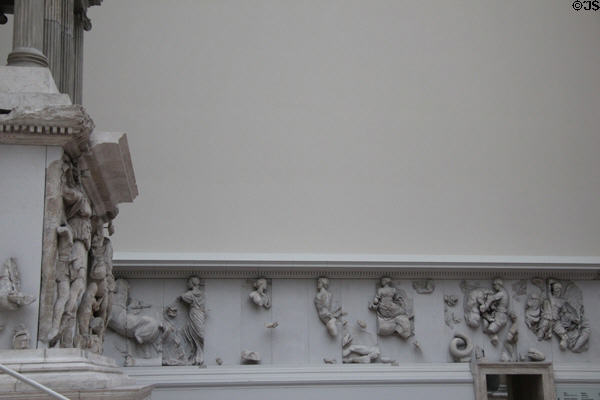 Frieze carving originally around exterior perimeter of Pergamon altar now displayed on interior museum walls in front of the ancient structure (c170 BCE) at Pergamon Museum. Berlin, Germany.