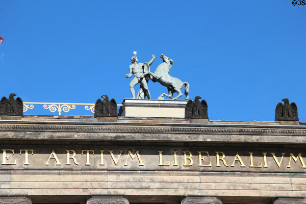 Statue of Greek-style figure & horse plus eagles atop Altes Museum Berlin (1830). Berlin, Germany.