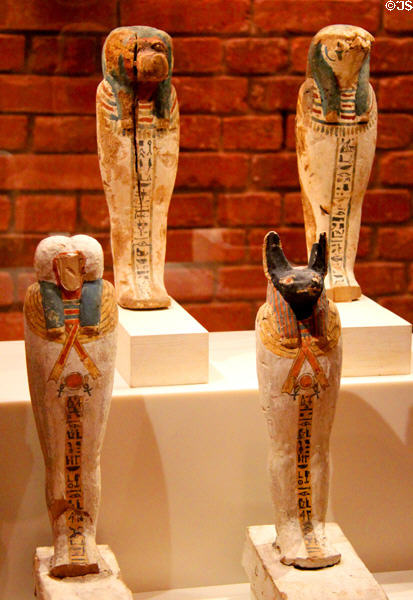 Egyptian wooden protective figure of falcon Horus & baboon Hapy & jackal (746-332 BCE) (Late Period) at Neues Museum. Berlin, Germany.