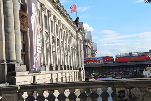 Passenger train crosses bridge between Bode & Pergamum Museum. Berlin, Germany.