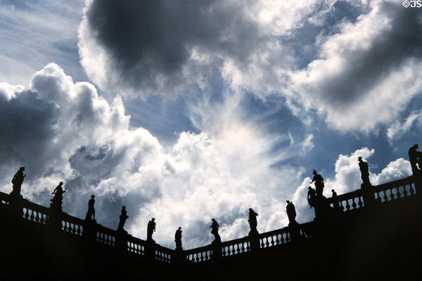 Roofline statues against sky atop University of Potsdam buildings west of New Palace at Sanssouci Park. Potsdam, Germany.
