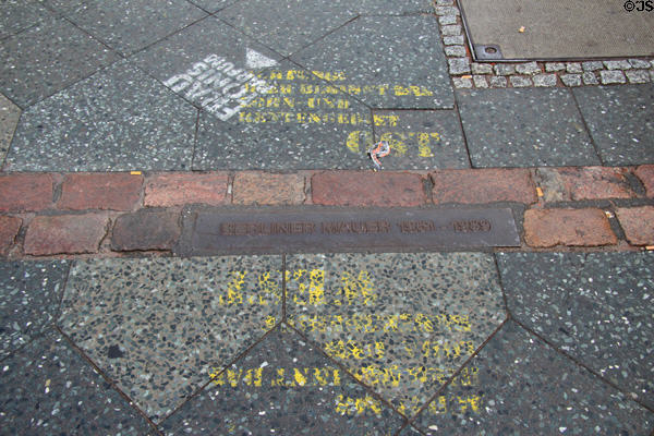 Brick line in pavement marks where Berlin Wall once stood near Checkpoint Charlie. Berlin, Germany.