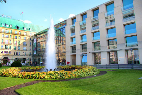 White vertical pillars of Gehry's DZ Bank building at Pariser Platz 3 to right of Hotel Adlon. Berlin, Germany.