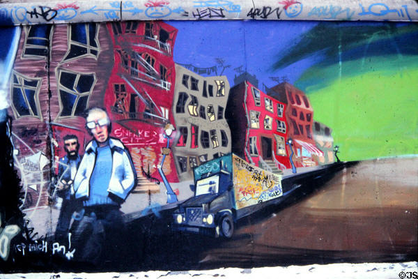 Berlin Wall with modern red building being constructed on western allied side. Berlin, Germany.