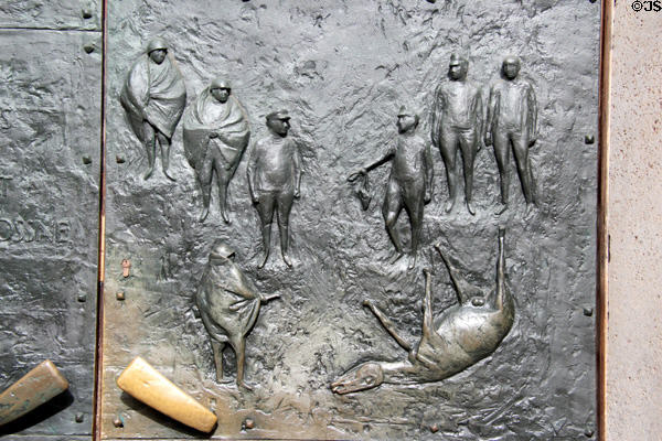 Detail of Greifswald Town Hall bronze doors (1965) by Joachim Jastram shows towns surrender to Russian troops. Greifswald, Germany.