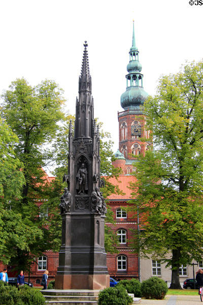 Heinrich Rubenow monument with St Nicholas Church tower. Greifswald, Germany.