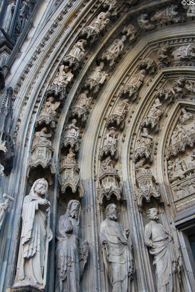 Carved figures in Gothic arch of south entrance doors to Köln Cathedral. Köln, Germany.