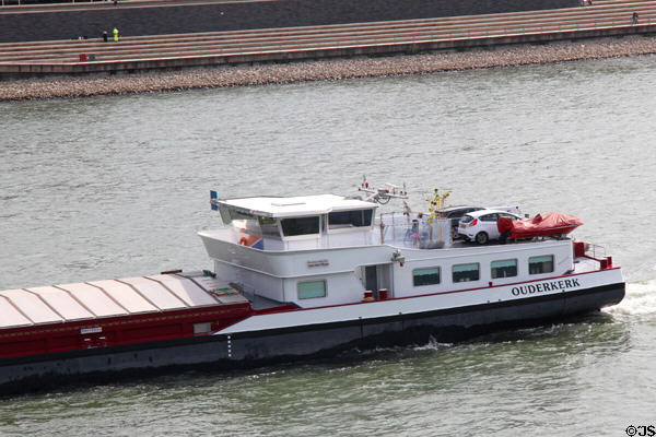 Barge with family car on deck traveling along Rhine River. Köln, Germany.