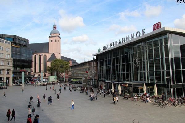 Entrance to Köln Central Station (rebuilt 1957) St Mariä Himmelfahrt church beyond. Köln, Germany.