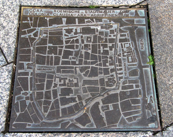 Modern bronze plaque in pavement with street map of Roman Köln within city walls near Roman Germanic Museum. Köln, Germany.
