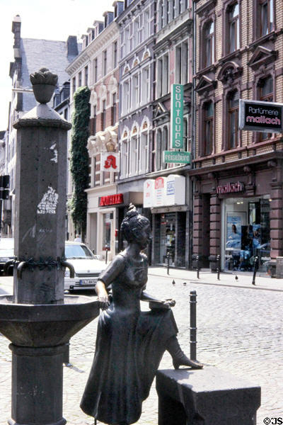 Statue at water fountain in front of St Severin Church. Köln, Germany.