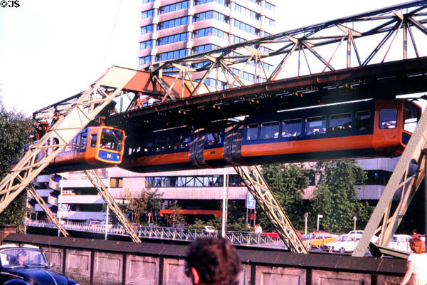 Hanging monorail running parallel to city road. Wupperthal, Germany.