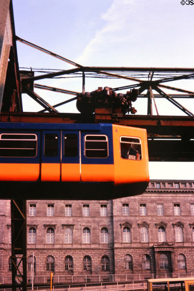 Hanging monorail leaving station. Wupperthal, Germany.