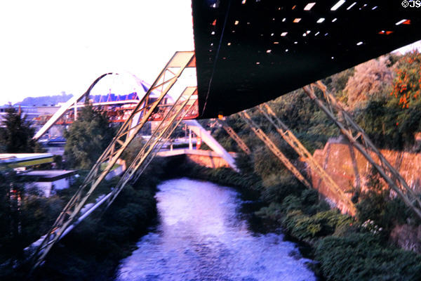 Hanging monorail track follows river through city's narrow valley. Wupperthal, Germany.