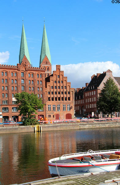 Heritage buildings along Holsten Hafen with St Mary's church beyond. Lübeck, Germany.