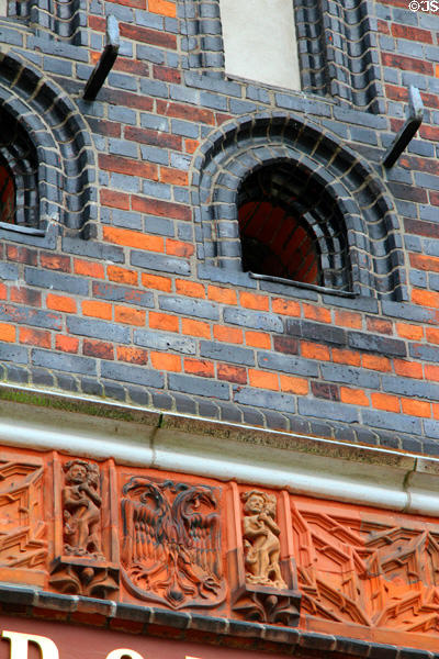 Terra cotta eagles & figures over archway of Holsten Gate. Lübeck, Germany.