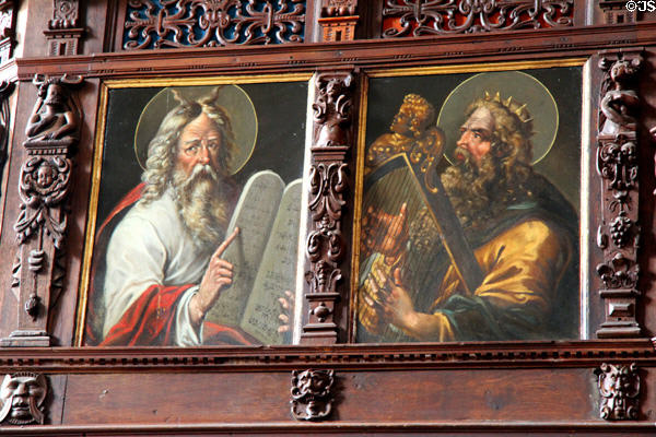 Paintings of Moses with horns holds tables & King David play harp on organ loft at St Jacob's Church. Lübeck, Germany.