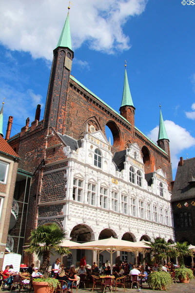 White Renaissance arcade (1570-2) by Hans Fleminck & Herkules Midow below brick Gothic shield wall at Lübeck Rathaus. Lübeck, Germany.