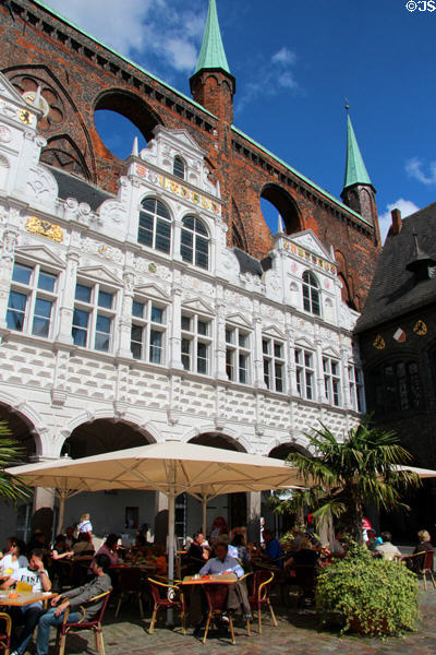 Cafe at Renaissance arcade below Gothic shield wall at Lübeck Rathaus. Lübeck, Germany.
