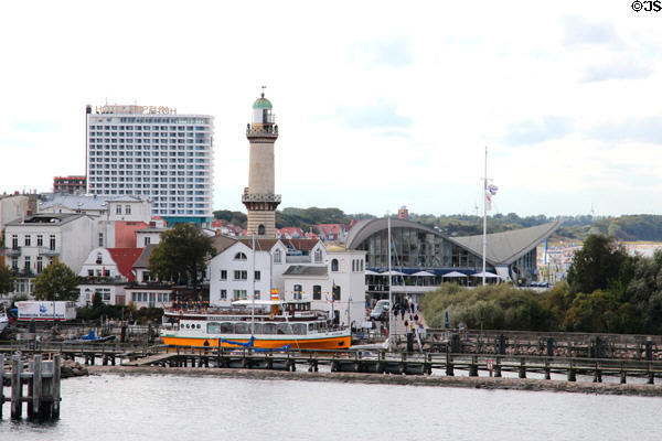 Warnemünde Lighthouse (1898) of Warnow river over Selene tourboat. Rostock, Germany.