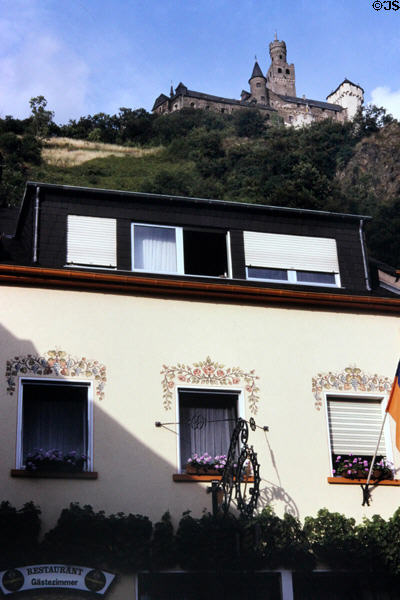 Restaurant painted with grapes & flowers beneath castle. Germany.