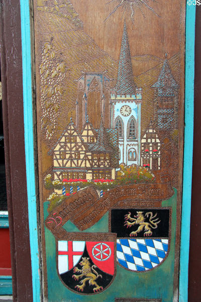 Sign on shop illustrating Bacharach town crest & its wine production. Bacharach, Germany.