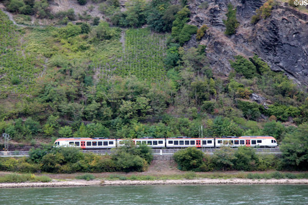 Passenger train traveling west bank of Rhine. Oberwesel, Germany.