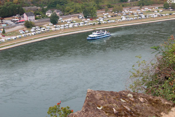 Sightseeing boat traveling along Rhine River as seen from viewpoint atop The Loreley with camper village beyond. Loreley, Germany.