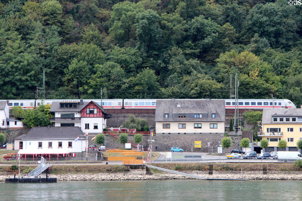 Passenger train traveling along bank of Rhine River. St. Goar, Germany.