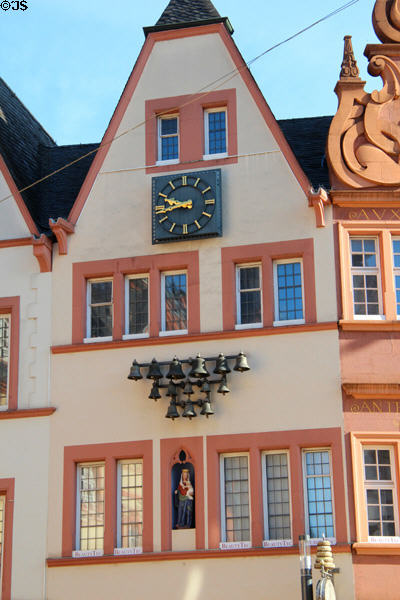 Rows of bells & Virgin Mary & Child statue adorning front of building on Hauptmarkt. Trier, Germany.