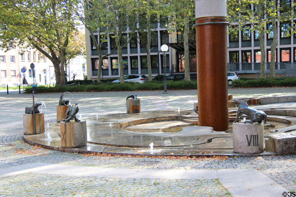 Water Clock Fountain (1984) with animal sculptures marking the hour & representing periods of Trier's history by Karl Jakob Schwalbach beside the Red Tower. Trier, Germany.