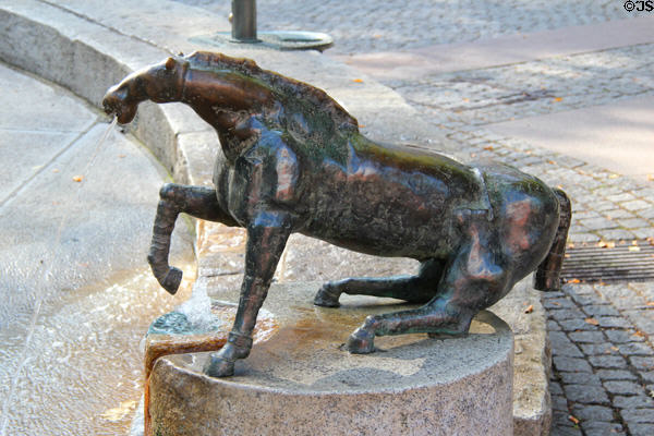 Horse marking the hour in Water Clock Fountain beside Red Tower. Trier, Germany.