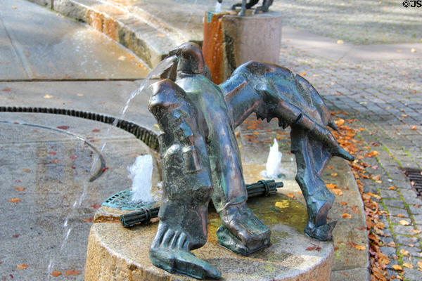 Eagle with bundle of sticks marking the hour in Water Clock Fountain beside Red Tower. Trier, Germany.