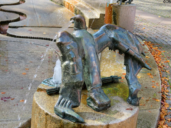 Eagle with bundle of sticks marking the hour in Water Clock Fountain beside Red Tower. Trier, Germany.