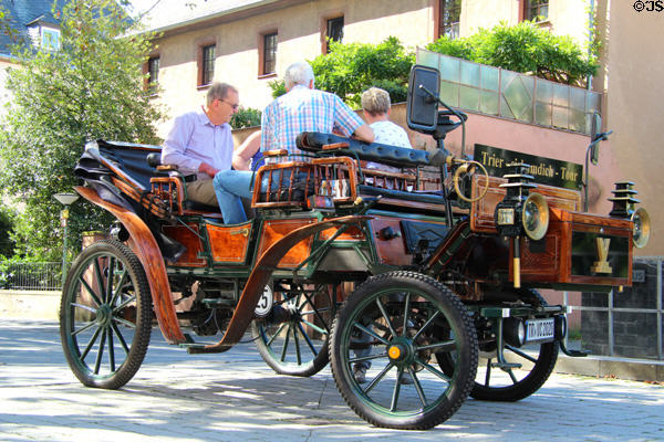 Horseless carriage touring historic Trier. Trier, Germany.