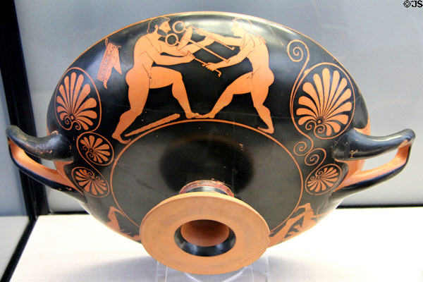 Greek terracotta red-figure drinking cup with Apollo & three footed stand of Delphi (c520 BCE) by Phintias at Antikensammlungen. Munich, Germany.