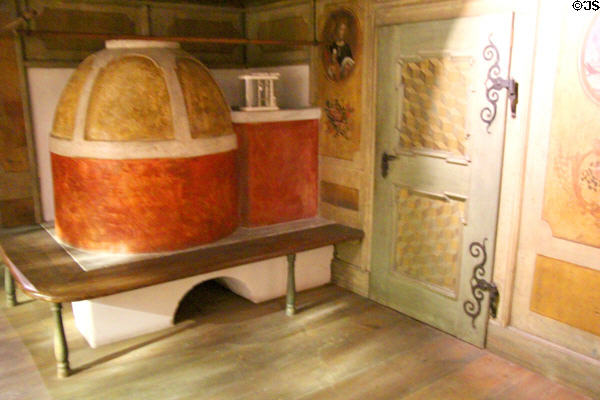 Room heating stove plus painted panels & cube illusions (c1770s) from Tirol at Bavarian National Museum. Munich, Germany.