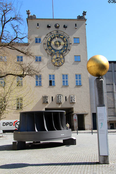 Clock above turbine in courtyard at Deutsches Museum. Munich, Germany.