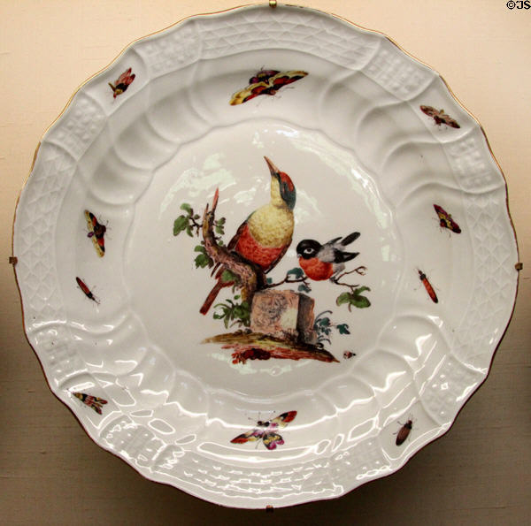 Meissen porcelain plate (c1750-60) with "Neubrandenstein" rim relief & painted bird decor at Meissen porcelain museum at Lustheim Palace. Munich, Germany.