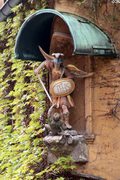 Statue of St George slaying the dragon, a common representation of devil at Fuggerei. Augsburg, Germany.