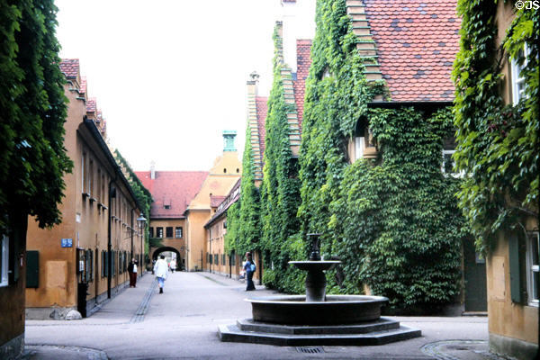 Streetscape with fountain at Fuggerei. Augsburg, Germany.