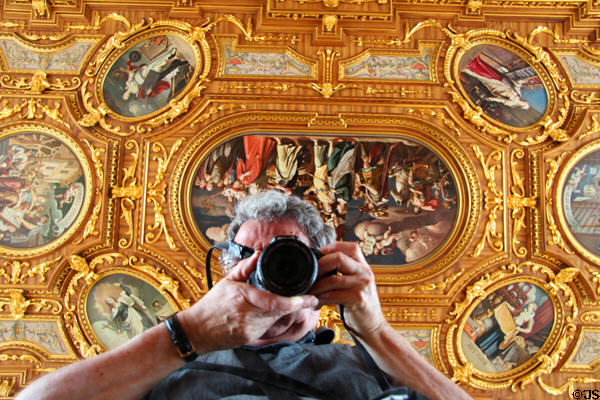 Photographer's reflection with ceiling via rolling table-top viewing mirror in Goldener Saal at Augsburg Rathaus. Augsburg, Germany.