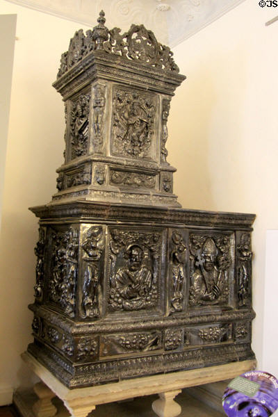 Ceramic room heating stove with relief's of religious figures at Bamberg City Museum. Bamberg, Germany.