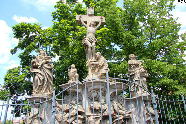 Crucifixion shrine sculpture on arched bridge traversing Bamberg Old Town Hall. Bamberg, Germany.