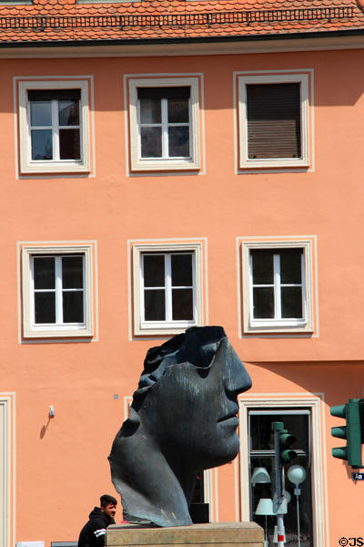 Sculpted Roman centurion partial head inspired by Pompeii (1987) by Igor Mitoraj on bank of Regnitz River. Bamberg, Germany.