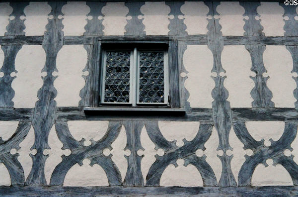 Half-timbered building with window made of multiple blown-glass rounds. Bamberg, Germany.